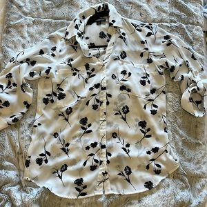 White blouse with black flowers.